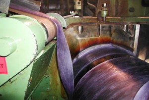 In the two-roll mill the hot plastic rope is squeezed into a thick, rough sheet of plastic. Photo courtesy of Achilles USA, Inc.