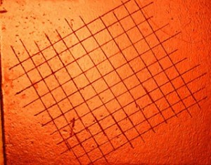 Using an X-Acto knife lightly cut cross hatch lines at a 90° angle forming a grid.
