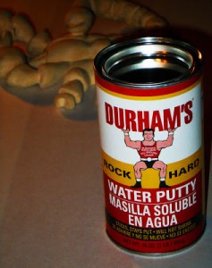 Durhan's Water Putty  bonds well to wood,  dries rock hard and does not shrink, even years after it has been applied